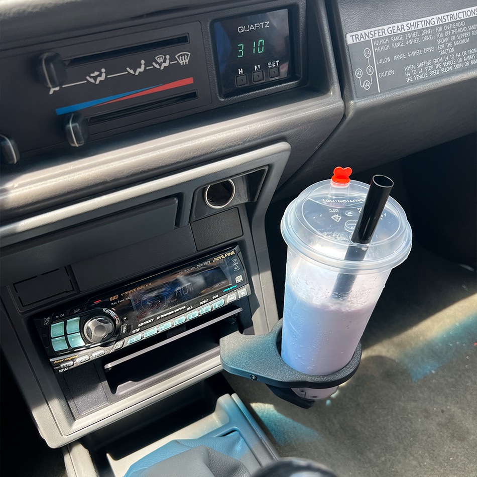 CaribouYota pull-out cup holder installed below a single-DIN radio