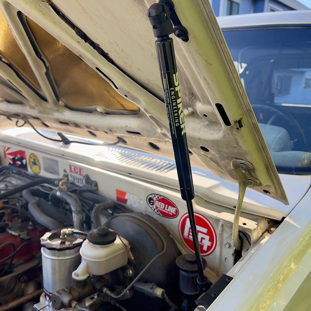 Spiker hood strut installed at the passenger side of a Toyota engine bay