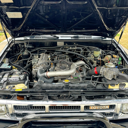 Toyota engine bay with hood supported by the bolt-on dual strut kit