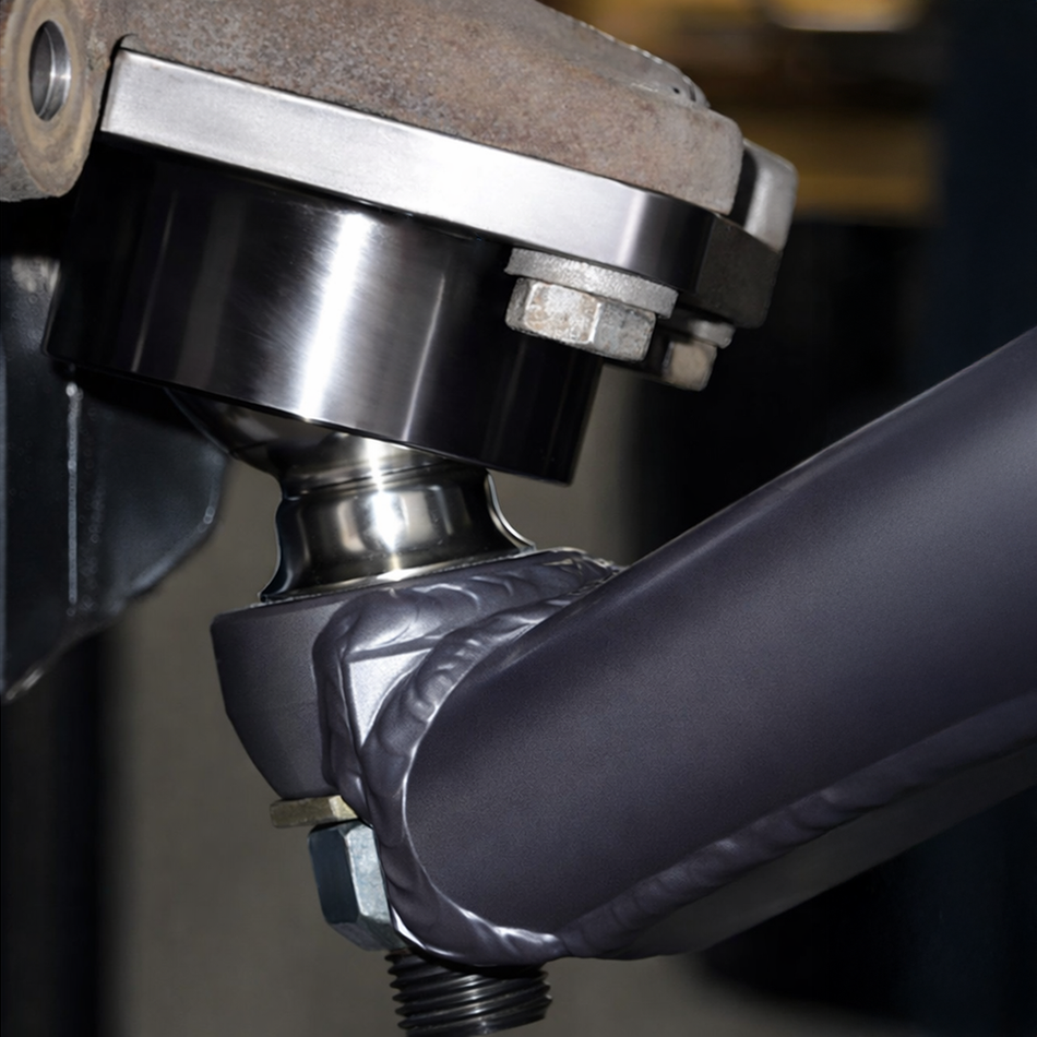 Total Chaos lower ball joint uniball conversion installed on a Toyota 4WD lower control arm