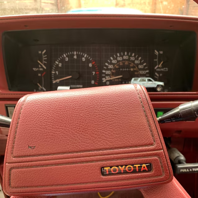 TRD-style TOYOTA steering-wheel decal installed at factory emblem location