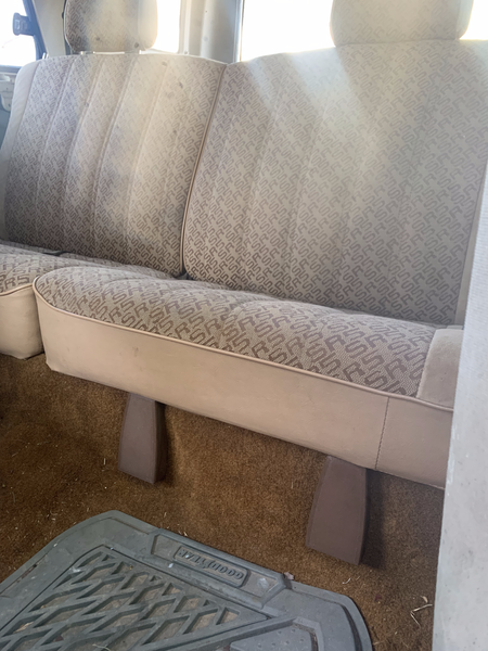 Brown rear seat hinge covers installed beneath the rear seat of a 1984-89 Toyota 4Runner